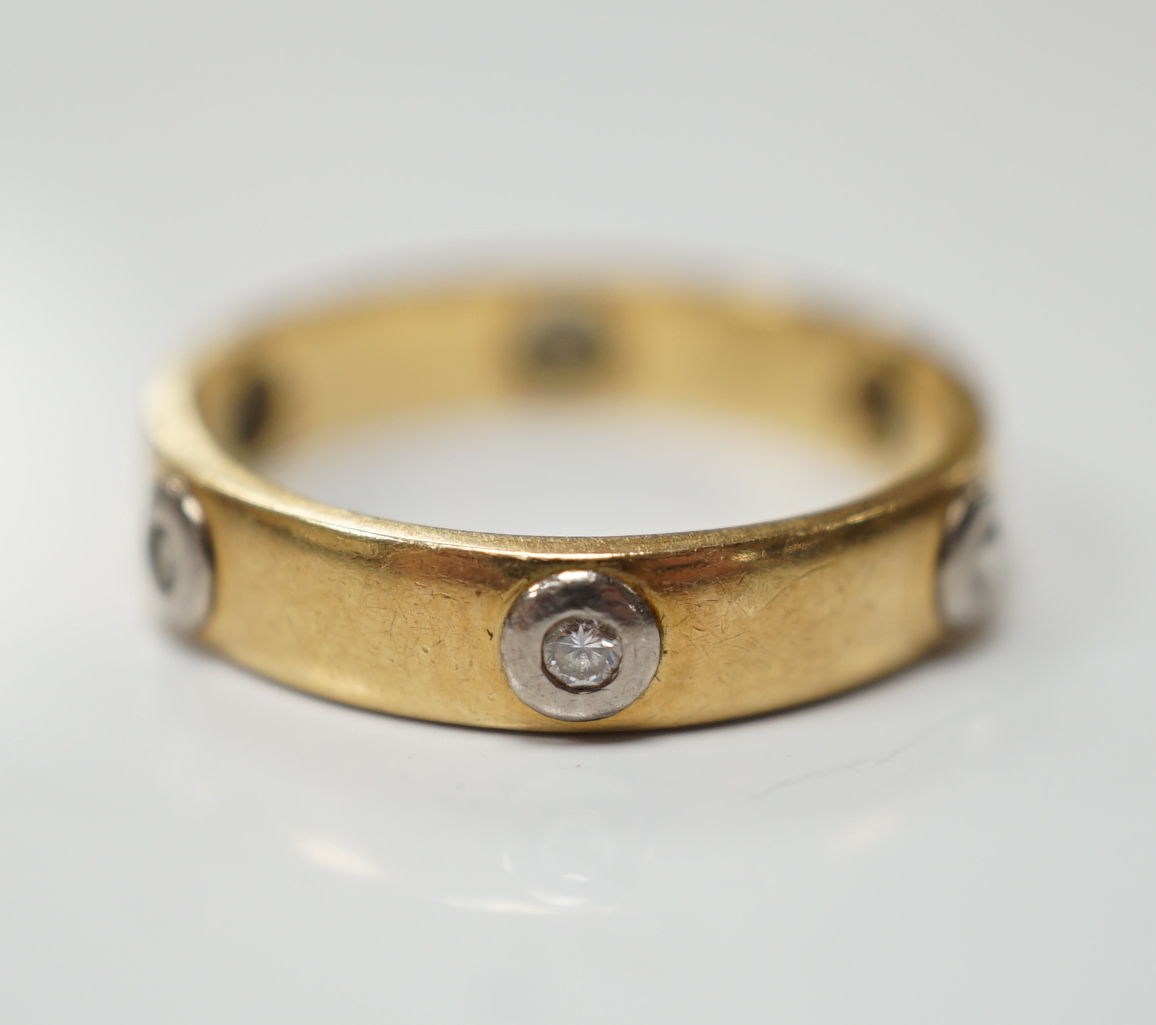 A modern Cartier 18ct gold and six stone diamond set band, signed and numbered 441404, size L, gross weight 3.3 grams, no box or certificate.